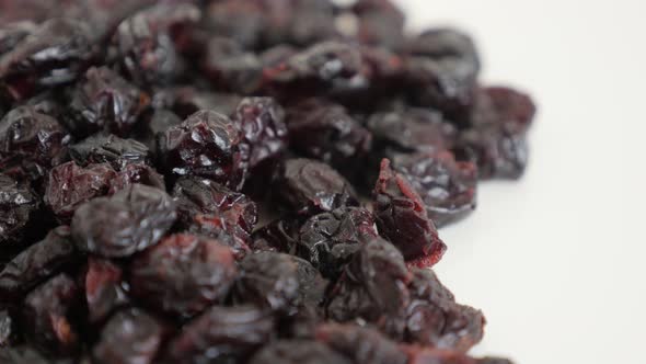 Pile of dehydrated cranberries slow tilt 4K 2160p 30fps UltraHD footage - Vaccinium oxycoccos dried  alt