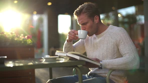 Slow Motion Handsome Intelligent Blond Caucasian Guy Enjoying Nice Spring Weather Sitting Outdoor alt