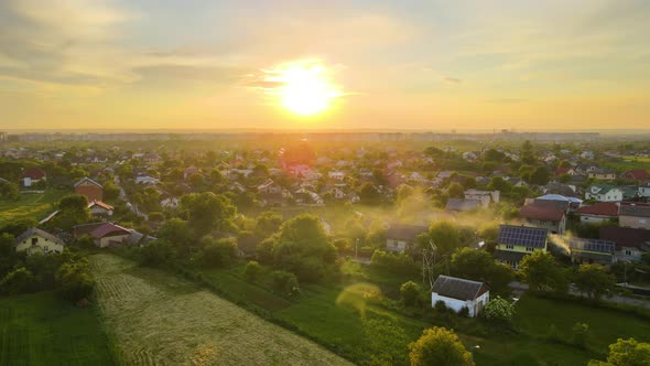 Aerial View of Residential Houses in Suburban Rural Area at Sunset alt