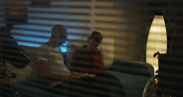 Grandfather Reading To Grandson alt