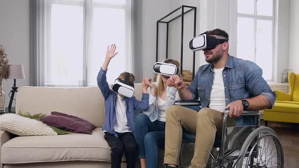 Modern Family which Enjoying Futuristic Entertaintment Using Virtual Reality Headset at Home alt
