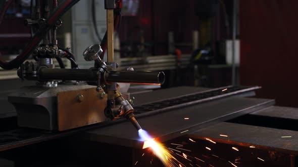 A Welding Machine is Processing the Edge of a Metal Sheet