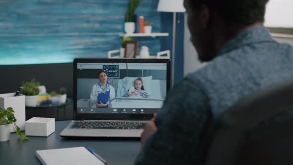 Online Video Call on Laptop Talking with Doctor From Hospital Ward alt