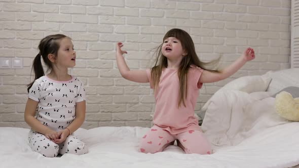 Two Cute Children Girls Playing in the Bedroom