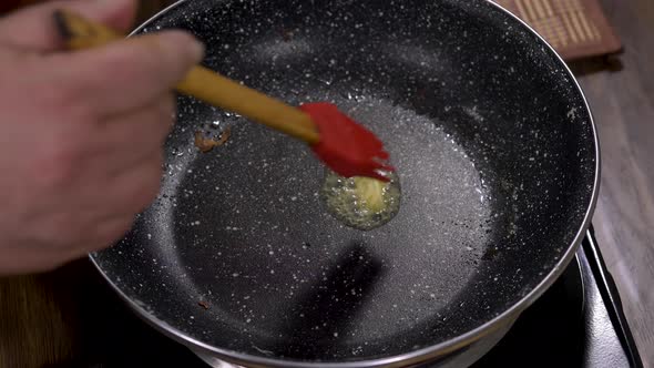 Piece of butter melting in a hot pan