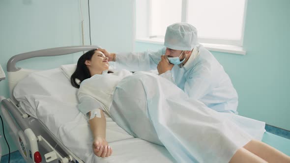 Pregnant Woman with Painful Contractions Holding Hand of Her Caring Husband That alt