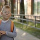 Male Smiled Pupil Wearing Glasses Carrying Backpack Go to School Holding the Book - VideoHive Item for Sale