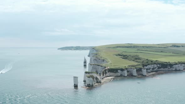 establishing drone shot of Old Harry Rocks Chalk cliffs alt