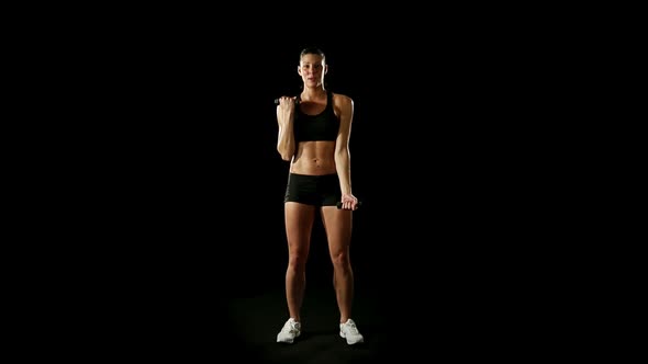 Young Athletic Woman Wearing Sporstwear is Exercising with Weights Slow Motion