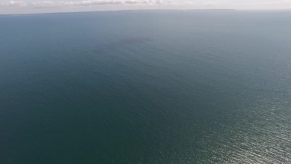 Drone flying over calm sea alt