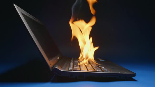 Laptop flaming on a table