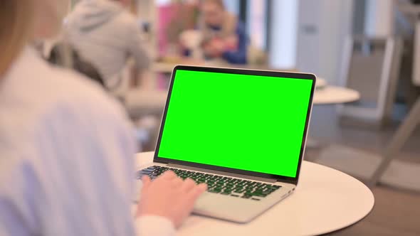 Woman Working on Laptop with Green Chroma Key Screen Rear View alt