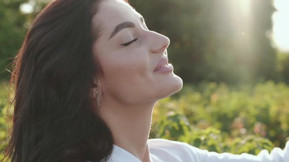 Free Brunette Undresses Hat and Rejoices to Sky with Sun Shining alt