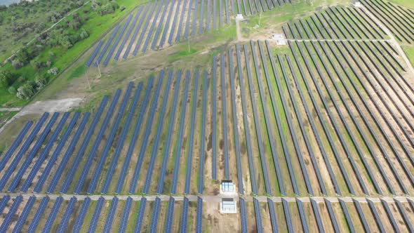 Aerial Top View on Solar Power Station in Green Field on Sunny Day. Solar Farm alt