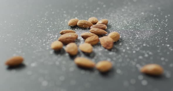 Video of almonds on grey background alt