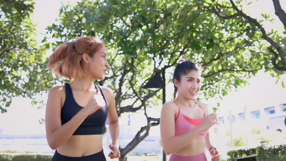 Female Friends Running in Park alt