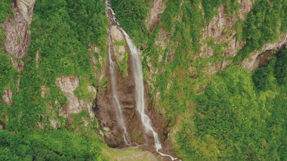 Mountain Waterfall Polikar. The Flow of Water Falls From a Cliff Overgrown with Trees alt