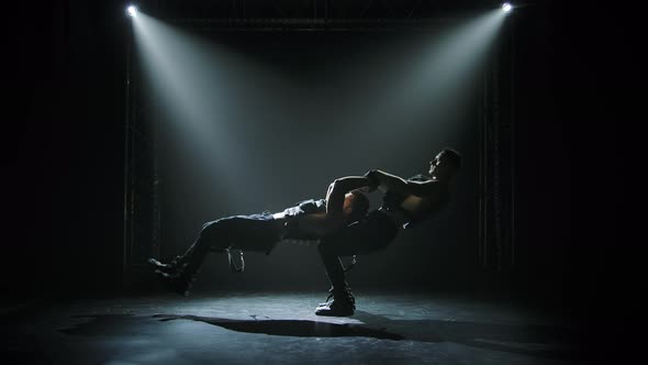 Two Gymnastic Acrobatic Men on Balance Pose, Silhouettes of Strong Athletic Men Performing Complex alt