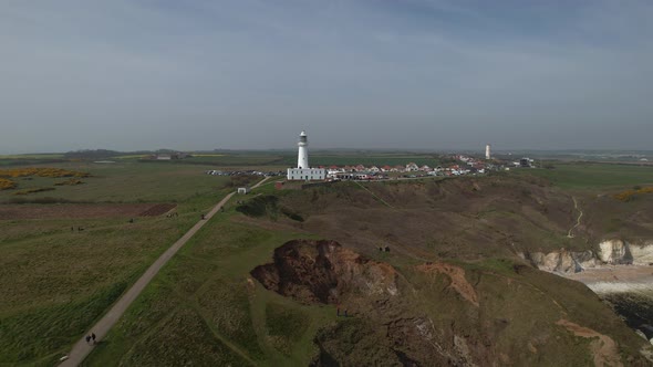 Push in aerial towards Flamborough Head Lighthouse East Riding Yorkshire England alt