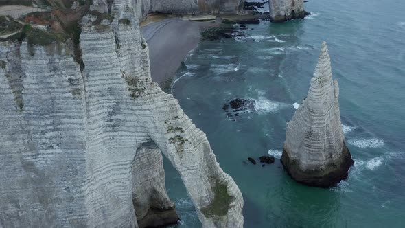 Incredible Aerial Overhead Aerial View of Etretat Cliff Arch in France with Sea Gulls Flying By alt
