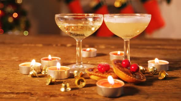 Wine glasses with christmas decorations on wooden table alt