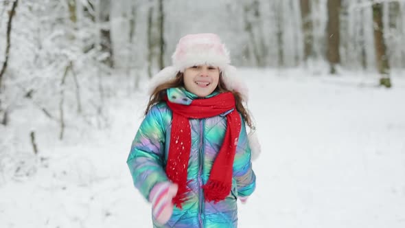 Child Girl are Having a Fun Running Between Snow Trees in Winter Time