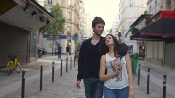Couple walking in the streets of Paris, France alt