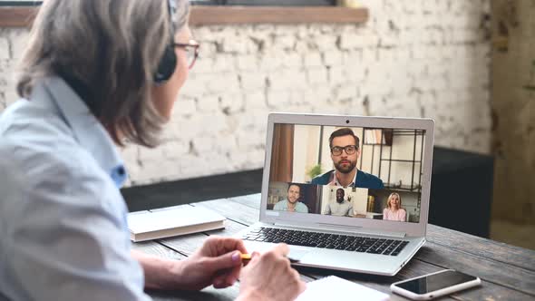 Woman in Front of Laptop Talking Online alt