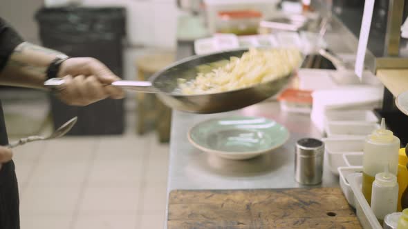 Close Up of Man Cooking Pappardelle in the Restaurant