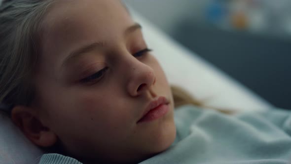 Closeup Sick Girl Lying in Hospital Bed Alone alt