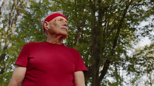 Senior Sport Runner Man Using Smart Watch Tapping Touchscreen, Tracking Result After Fitness Workout alt