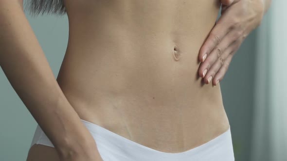 Reflection of Fit Woman in Underwear Pulling in Stomach, Weight Loss Program alt