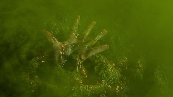 Hand Breaks Through Alien Cocoon In Green Gas alt