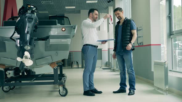 Salesman and Client Are Sealing the Deal on Buying a Boat alt