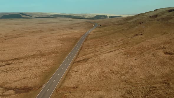 Abstract aerial view of Empty country road between brown dried up field alt
