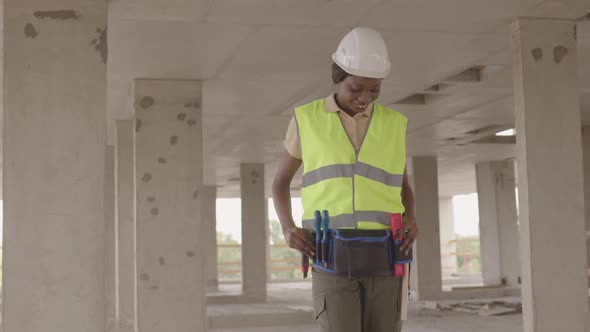 Female Construction Worker Posing on Site alt