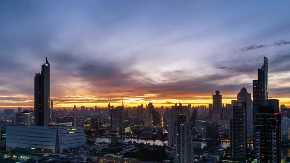 Sun rise over Bangkok business district city center, night to day, zoom in - Time Lapse