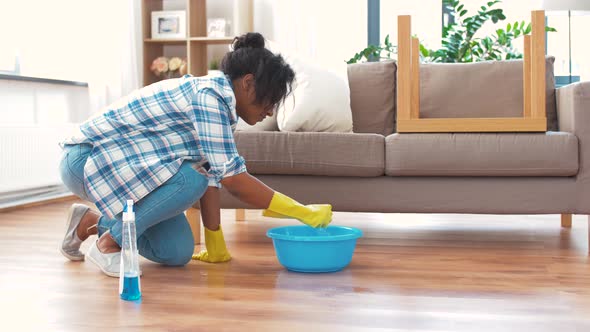 African Woman with Sponge Cleaning Floor at Home 39 alt
