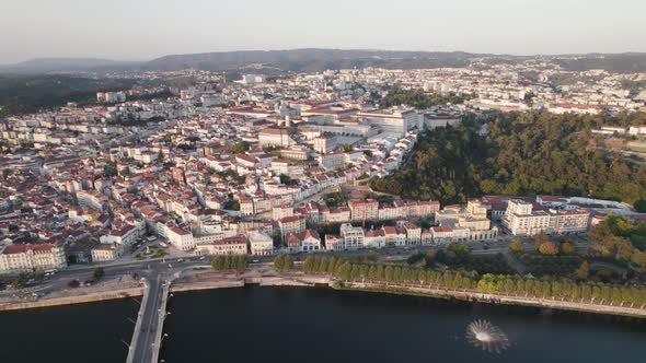 Coimbra city and Mondego river in Portugal. Aerial tilt-up descending alt