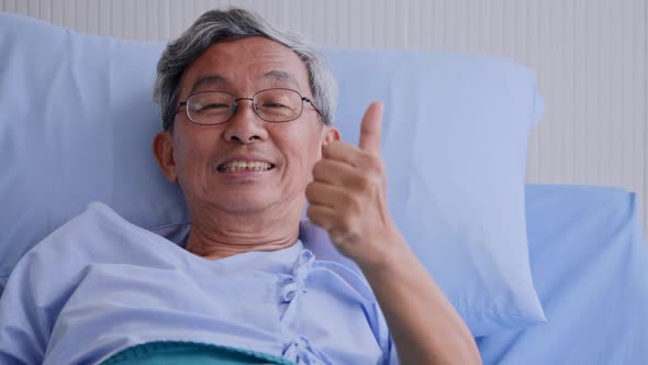 Close up of happy elderly man on patient bed at hospital alt
