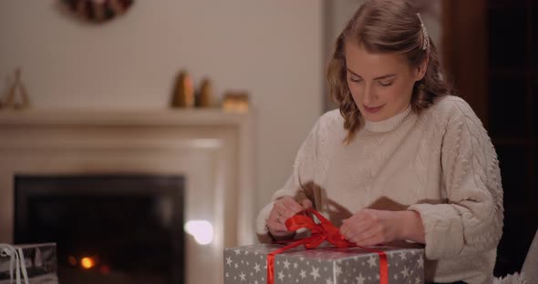 Happy Woman Unboxing Christmas Gift alt