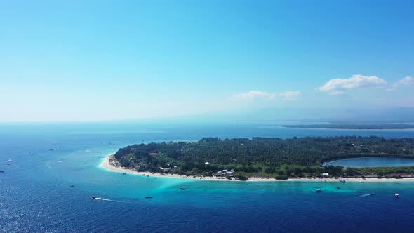 Gili Meno islands aerial seascape. Boat gliding in the calm turquoise sea water. alt