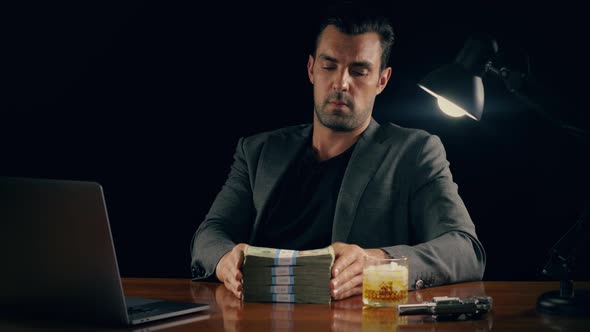 Handsome man plays with a stack of cash alt