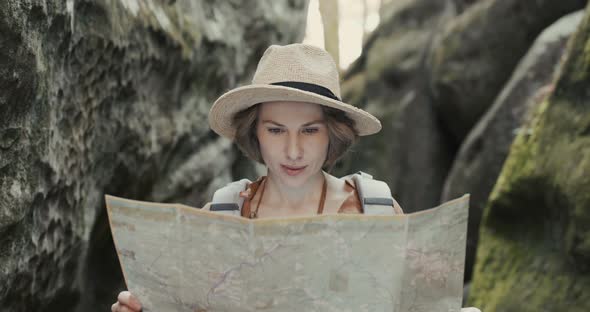 Stylish Traveler Girl in Hat Looking at Map alt
