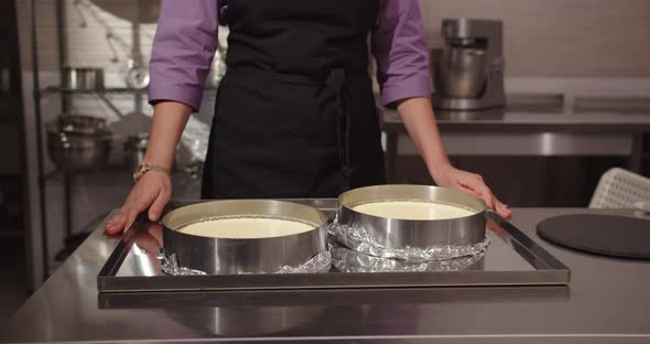 The Confectioner Girl In The Confectionery Takes Out The Finished Cakes And Will Decorate Them