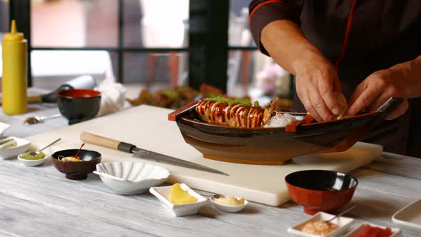 Male Hands Making Sushi Boat. alt