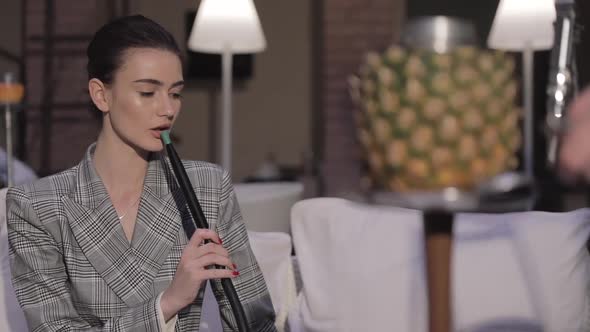 Smoke Hookah. Attractive Woman Smoking Pineapple Shisha At Bar