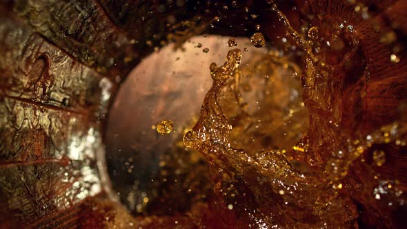 Super Slow Motion Shot of Splashing Whiskey in Old Oak Barrel at 1000Fps alt