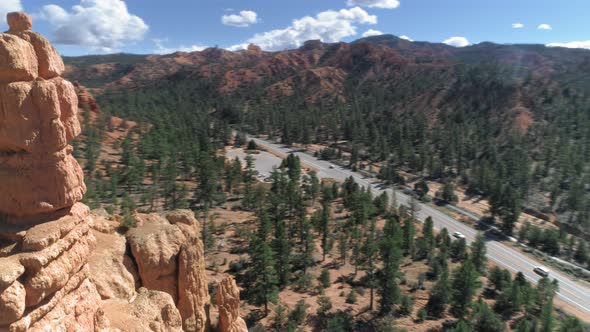  Aerial Over Beautiful Red Rock Formations and Road. Bryce Canyon, Utah, USA alt