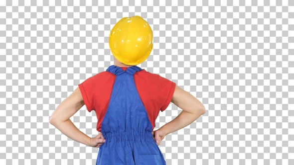 Female construction worker with hands on hips looking at alt